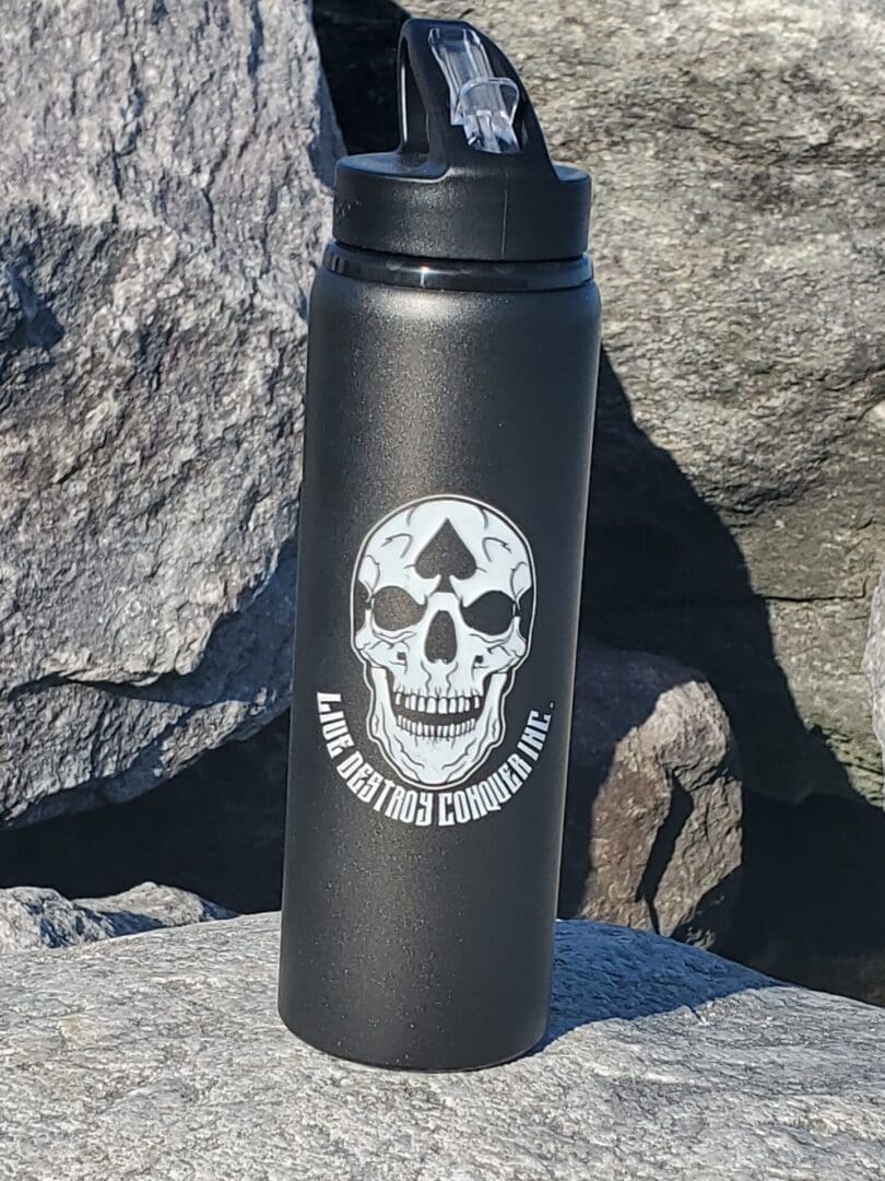 A black water bottle with a skull on it.