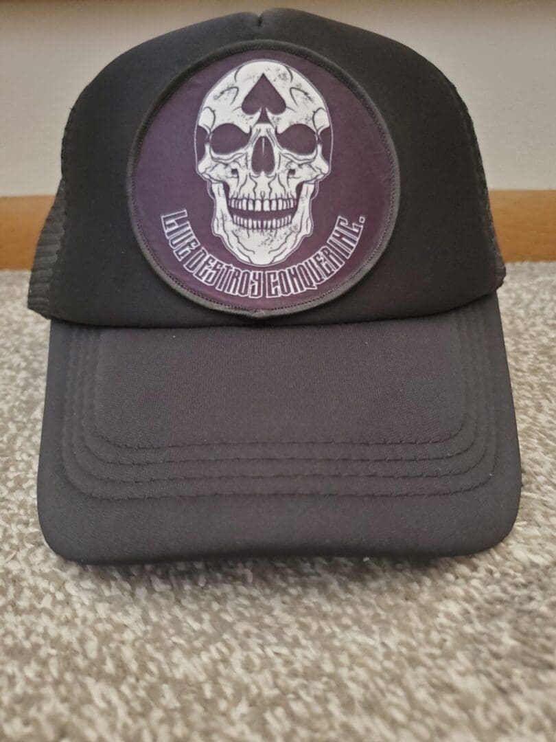 A hat with a skull on it sitting on the floor.