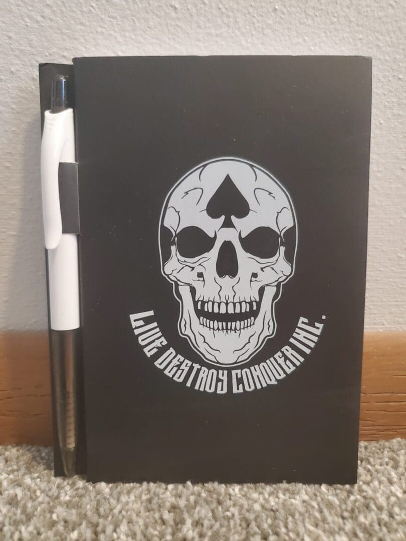 A black notebook with a skull on it