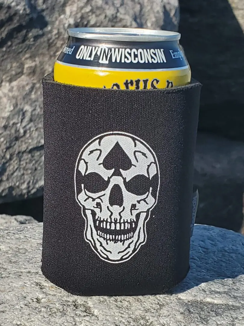 A can of beer is sitting on the rocks.